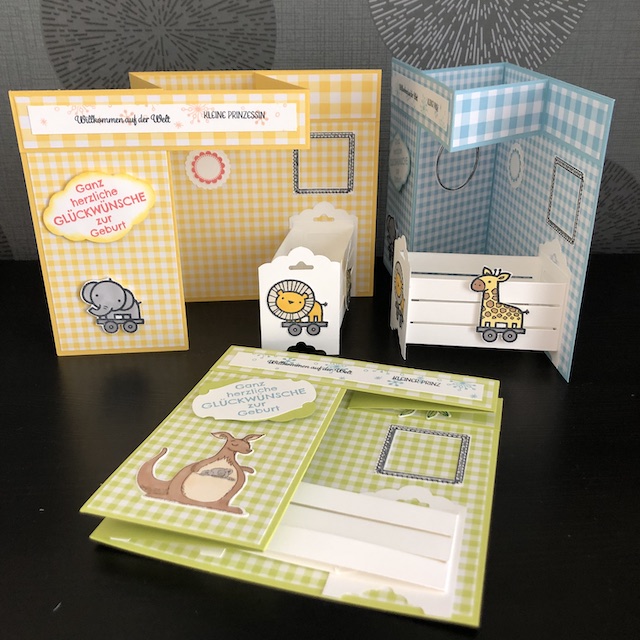 Double Z Fold Babycards. Eine Babykarte mit Effekt. Zu sehen ist eine Karte mit einem weißen Kinderbettchen. An der vermeintlichen Wand hängen leere Bilderrahmen, in die die Daten des Babys eingetragen werden können.