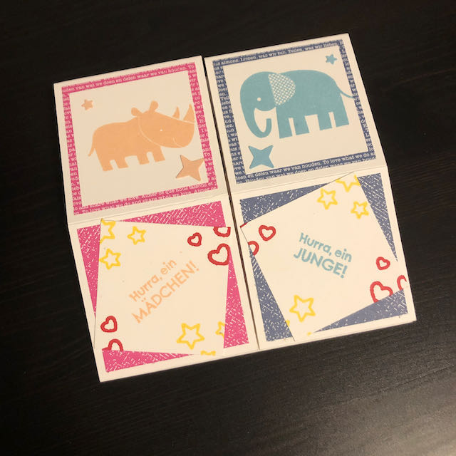Triple Pop Up Cube Card für Zwillinge. Die Karte ist in Pink und Blau gebastelt. Die Seite für Amelie ist pink mit Sternen und einem Nashorn und die Seite für Max ist blau mit Sternen und einem Elefanten. 