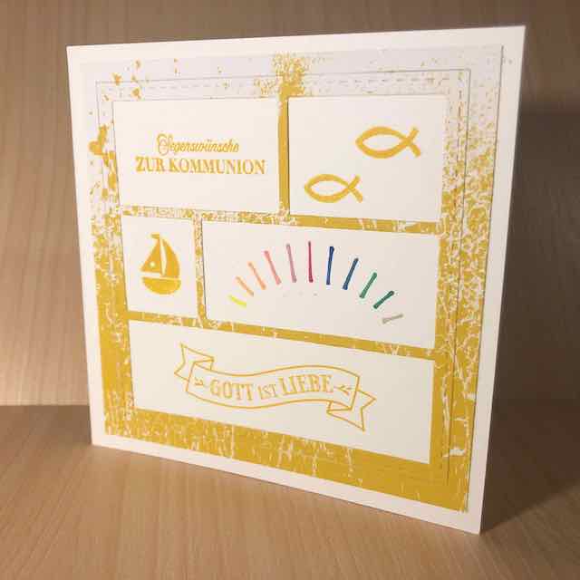 Eine Karte zur heiligen Erstkommunion. Darauf gestempelt sind unter anderem zwei Fische, ein Segelboot, ein Banner mit den Worten: Gott ist Liebe und ein Regenbogen. Die Karte ist quadratisch und mit Produkten von Stampin Up gebastelt.