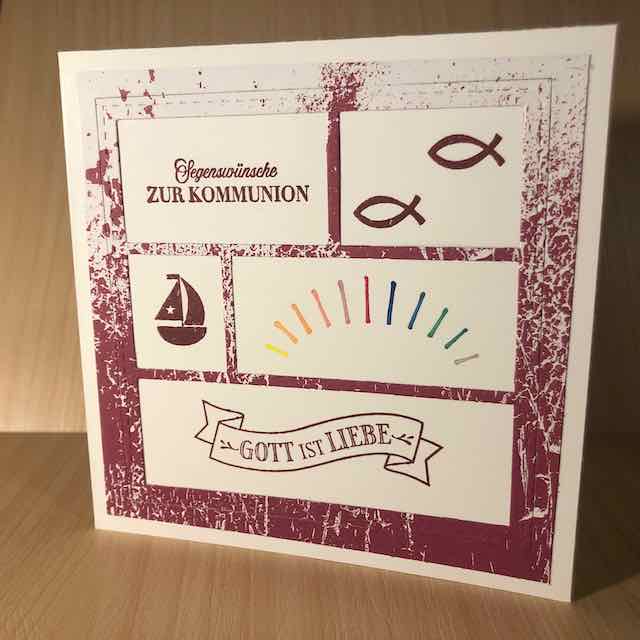 Eine Karte zur heiligen Erstkommunion. Darauf gestempelt sind unter anderem zwei Fische, ein Segelboot, ein Banner mit den Worten: Gott ist Liebe und ein Regenbogen. Die Karte ist quadratisch und mit Produkten von Stampin Up gebastelt.