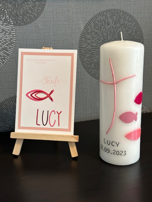 Glückwunschkarte zur Taufe mit Fischen und dem Namen in ausgestanzten Buchstaben. Passend dazu eine selbst gestaltete Taufkerze von Kerstins Kartenwerkstatt